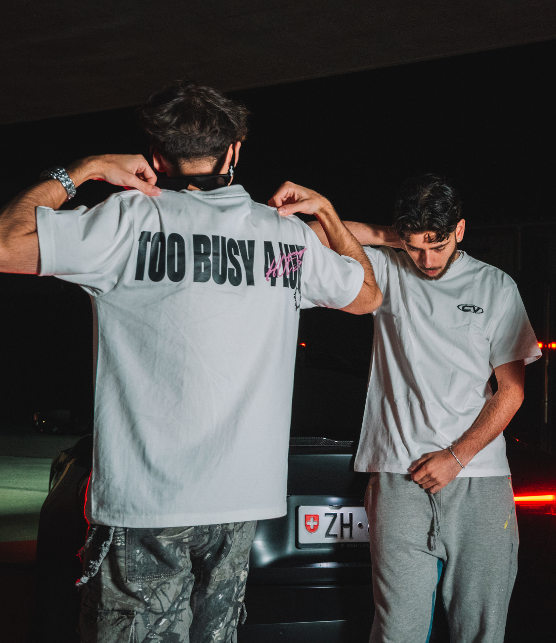 Model showcasing NOLUV TEE with "TOO BUSY 4 LUV" print, highlighting cotton fabric and stylish fit.