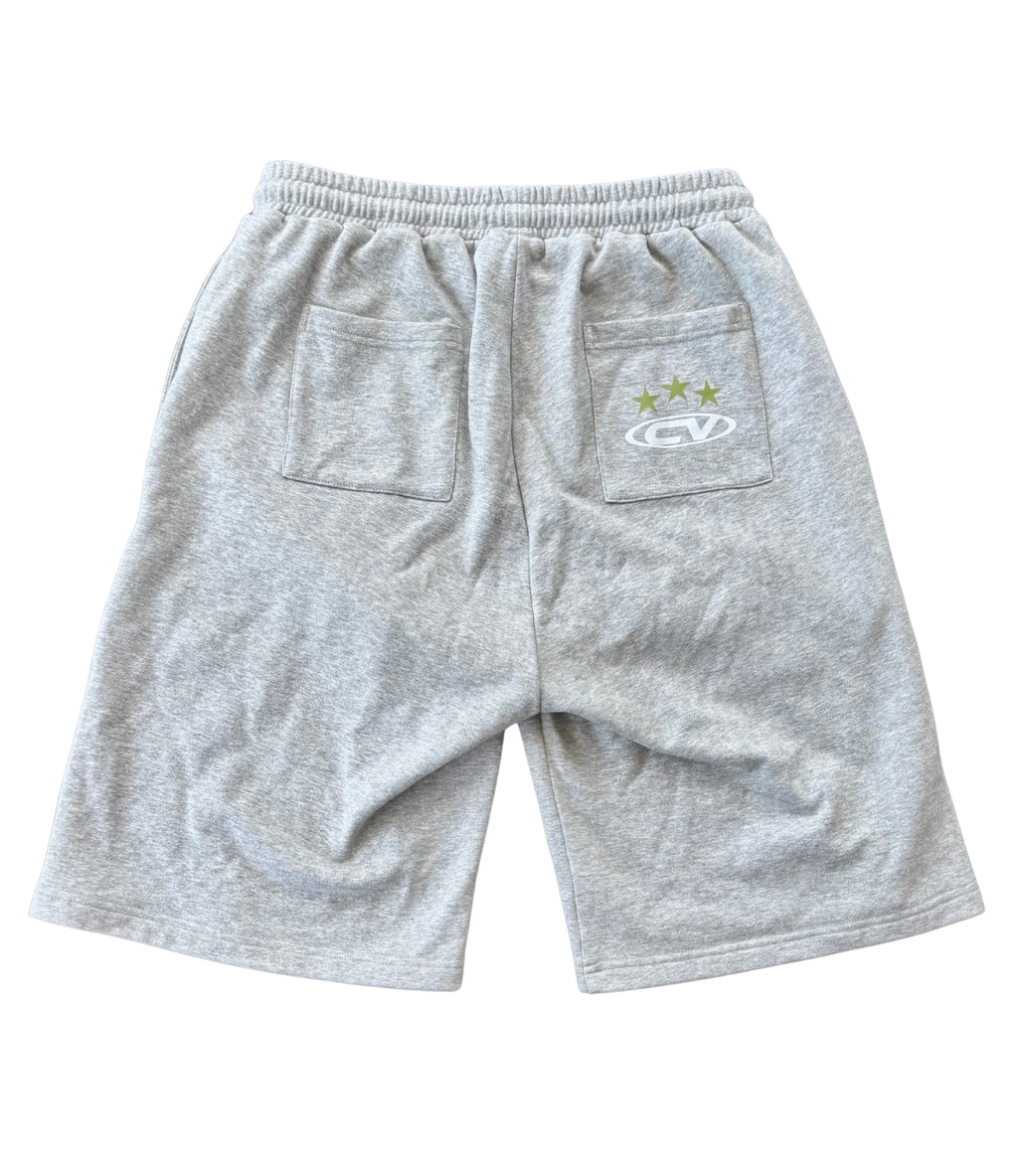 Back view of grey shorts with pockets, perfect for summer wear, paired with a longsleeve top.