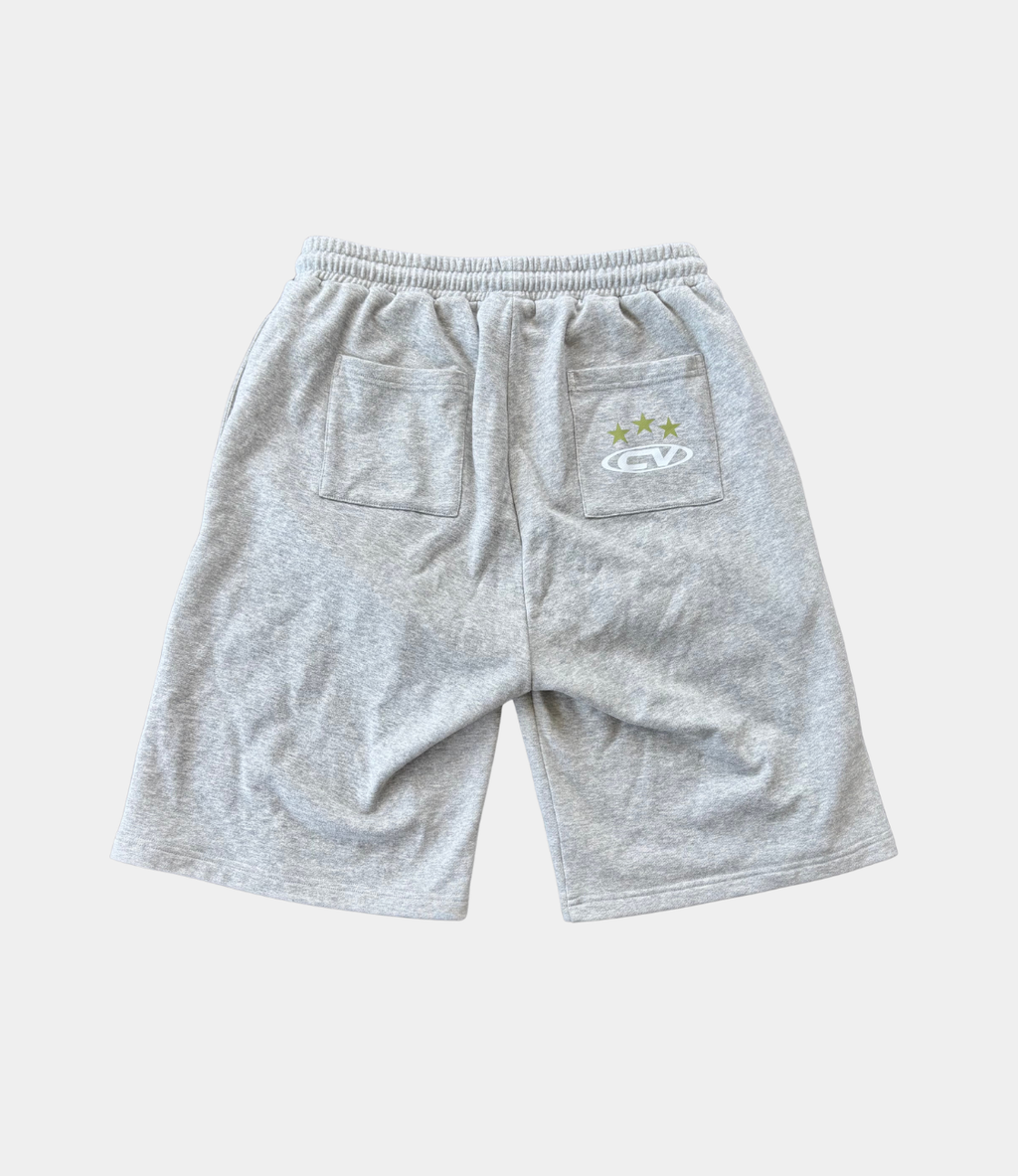 Back view of grey shorts with pockets, perfect for summer wear, paired with a longsleeve top.