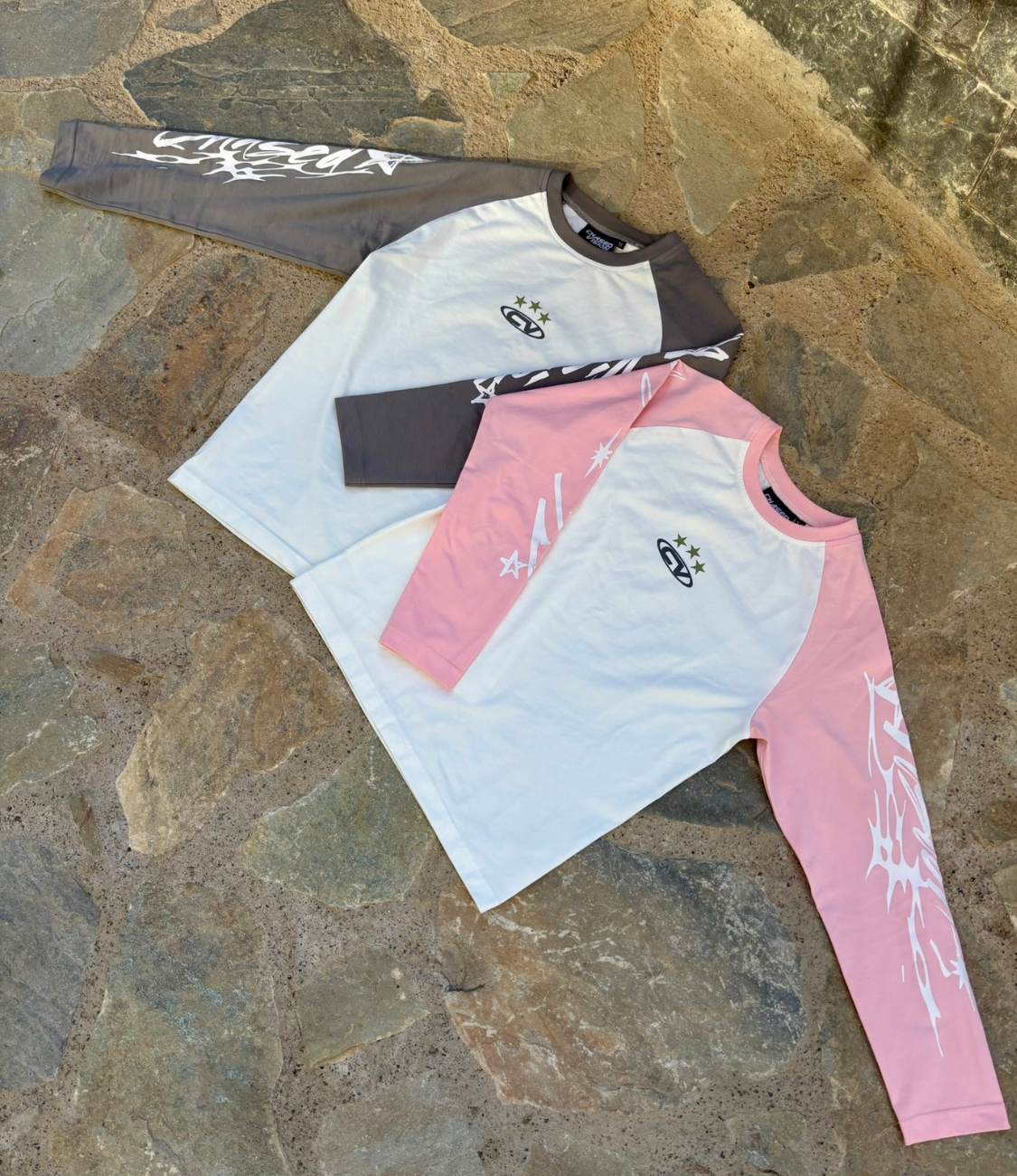 Pink and grey long sleeve shirts, perfect for summer styling with shorts. Fashionable and comfortable attire.