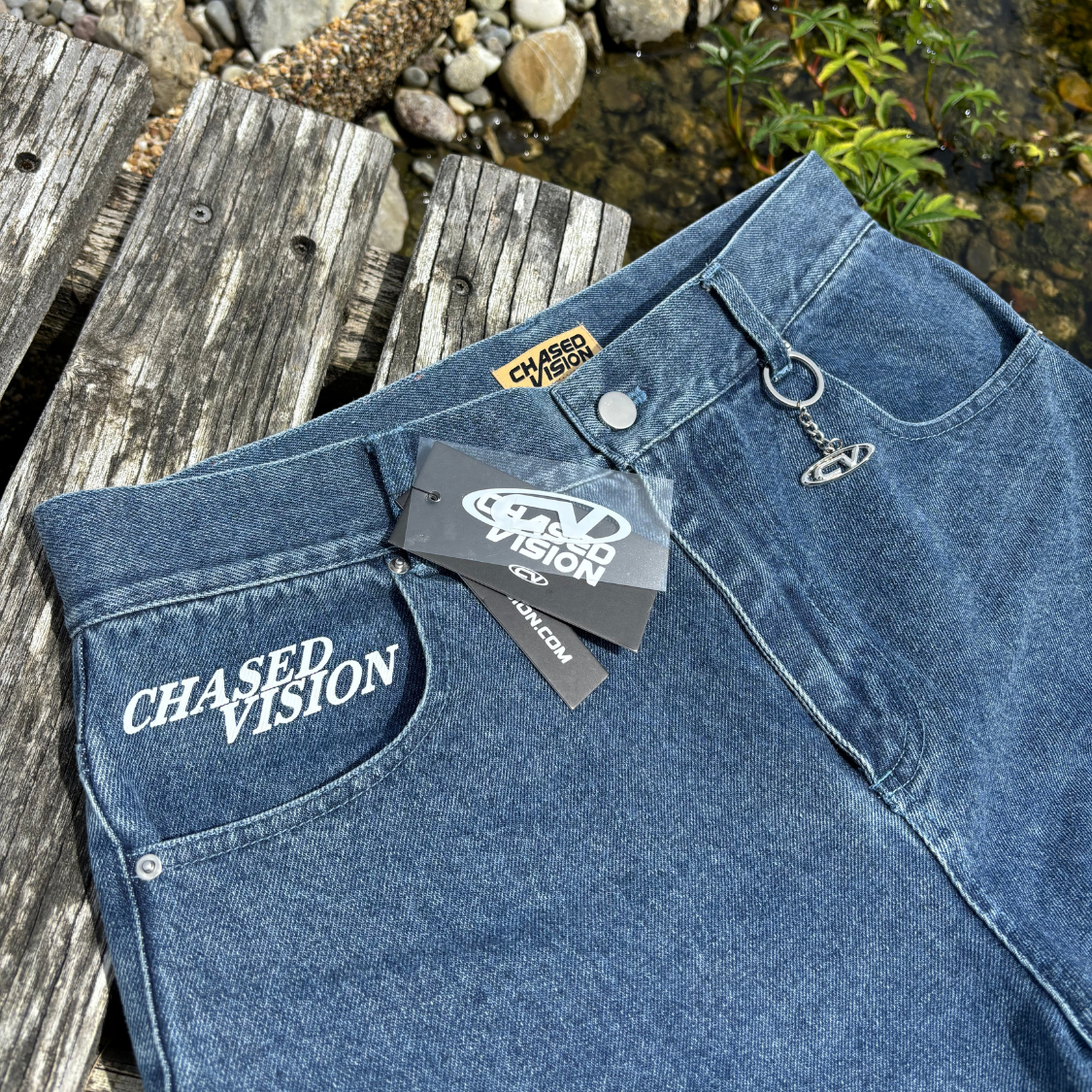 High-quality blue washed jorts with a perfect fit, many details, and keychain attached by Chasedvision on a wooden surface