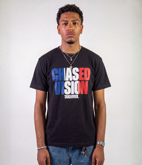 A male model wearing the black france worldcup tee from chasedvision with a "chasedvision takeover." design