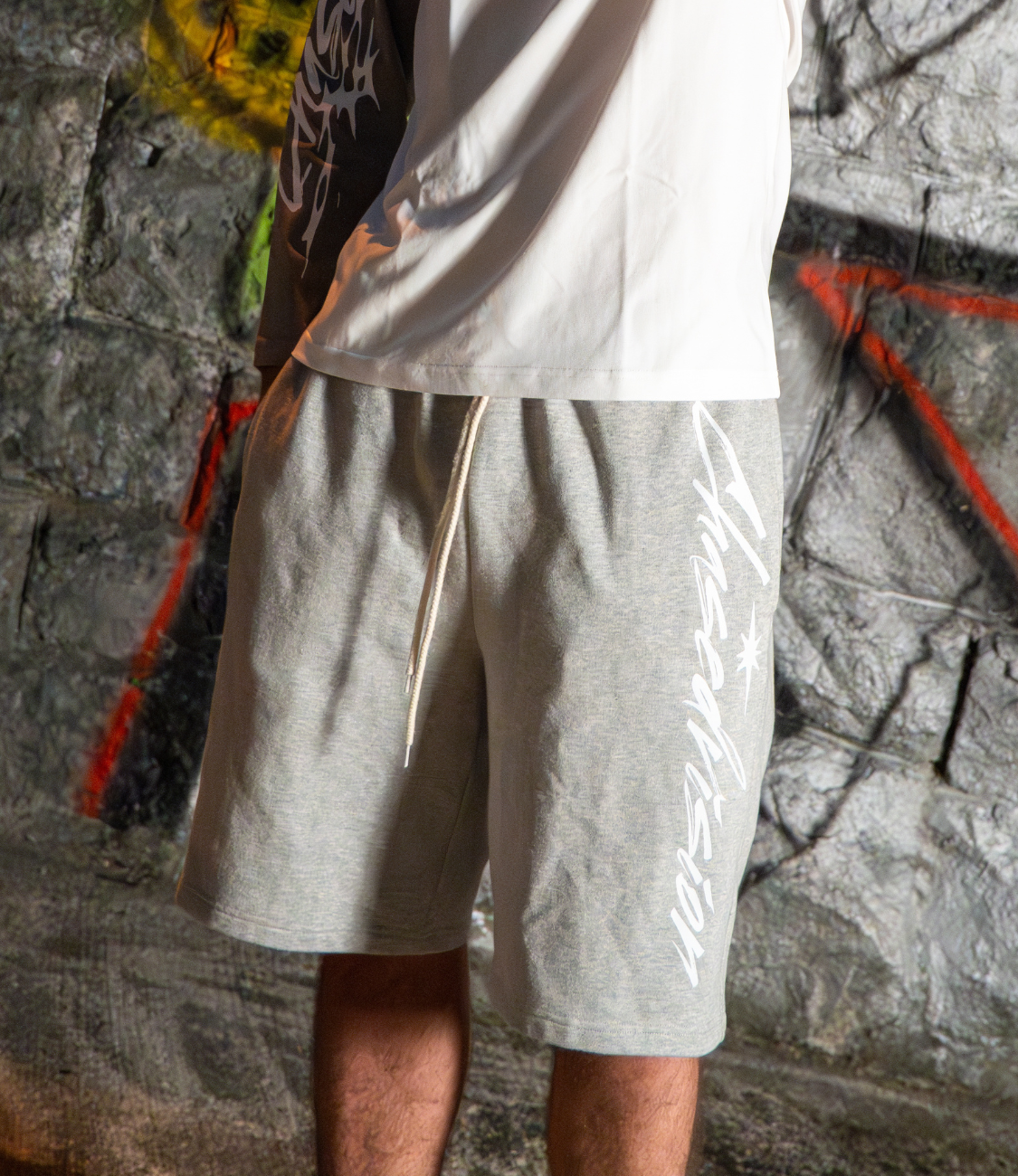Stylish grey shorts perfect for summer, paired with a longsleeve shirt, ideal for casual outings.
