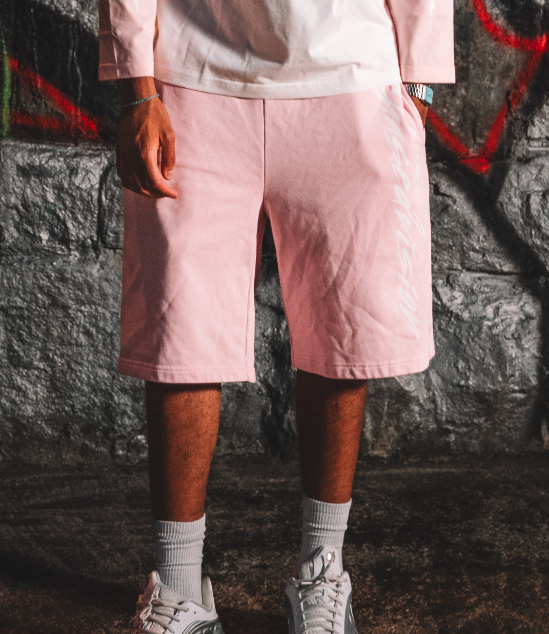 Pink summer shorts paired with a long-sleeve top, perfect for casual outdoor wear.