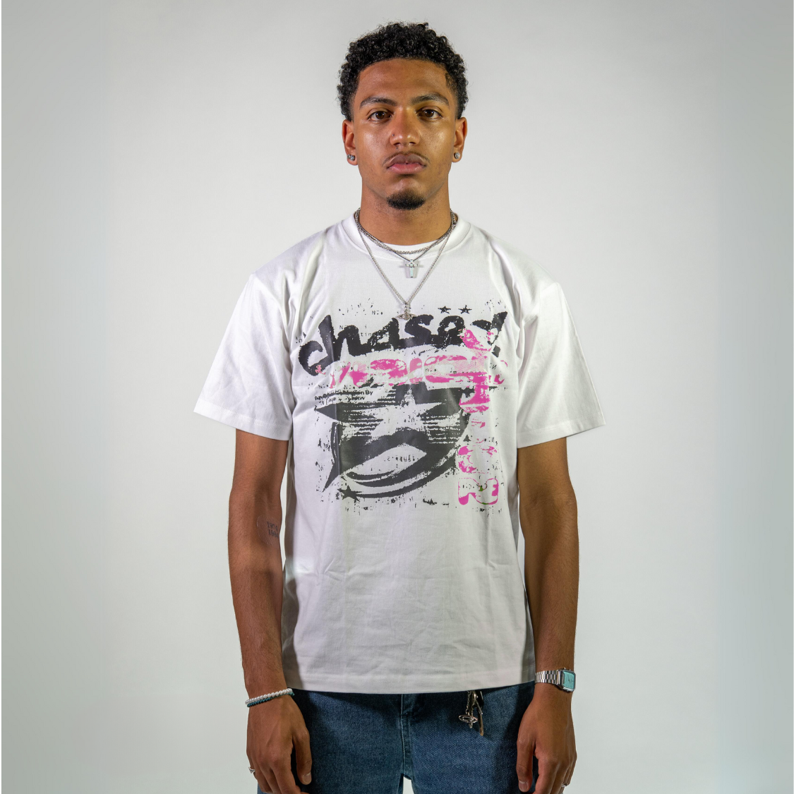 Man wearing a Chasedvision oversized cotton tee with pink design, showcasing perfect fit and high-quality streetwear style.