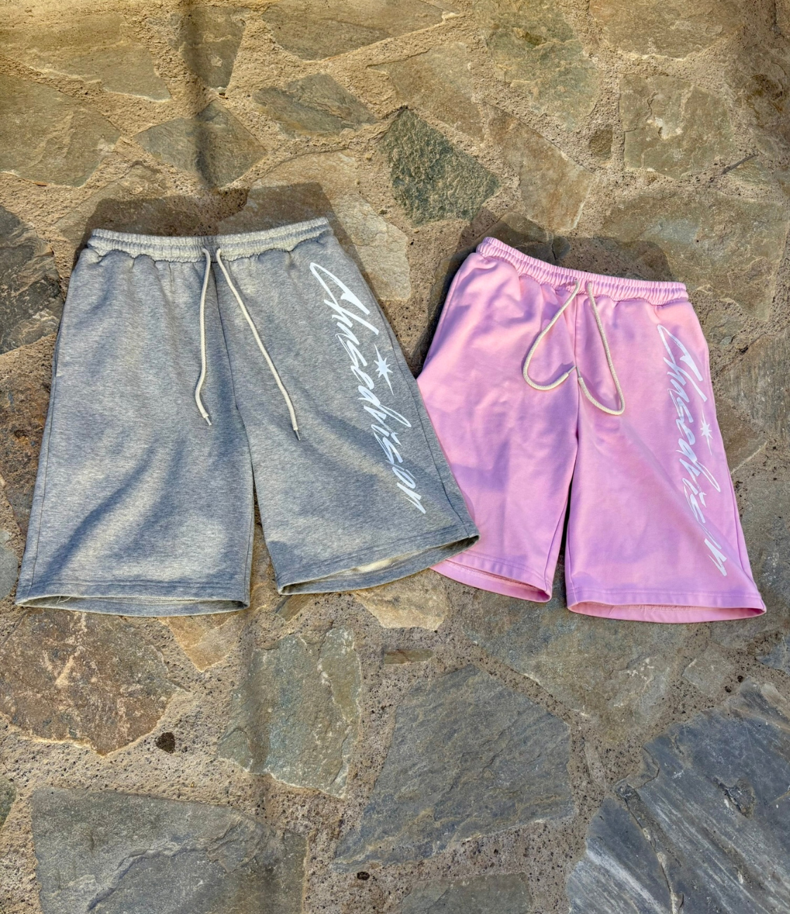 Two pairs of summer shorts: grey and pink, perfect for casual wear with longsleeve tops.